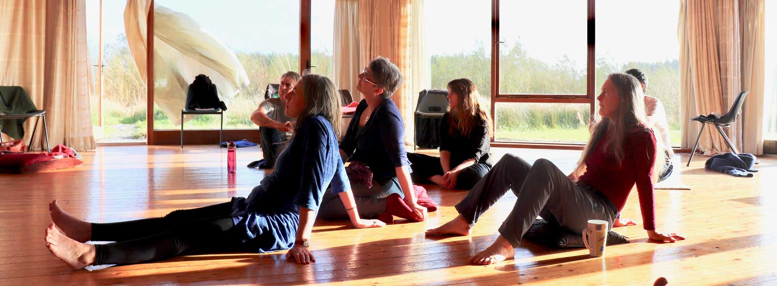 People sitting on the floor looking in the same direction