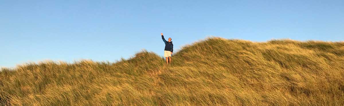 Philip Shepherd Waving on grassy Hilltop
