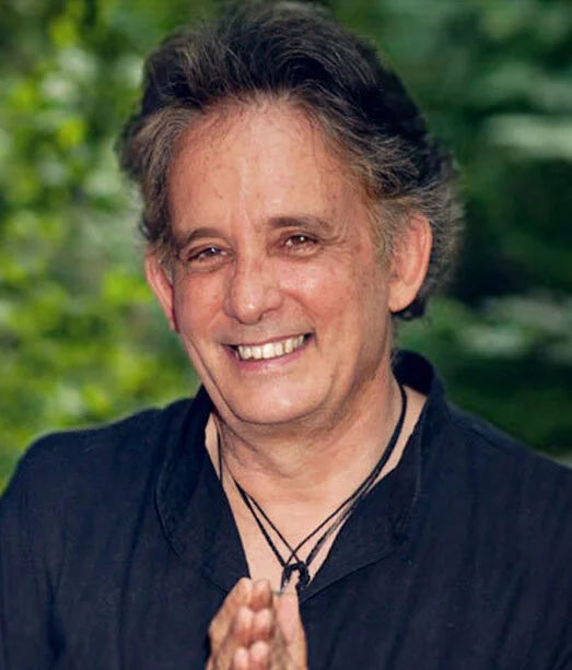 Andrew Harvey, TEPP participant, with gray hair and a black shirt against a blurred green background