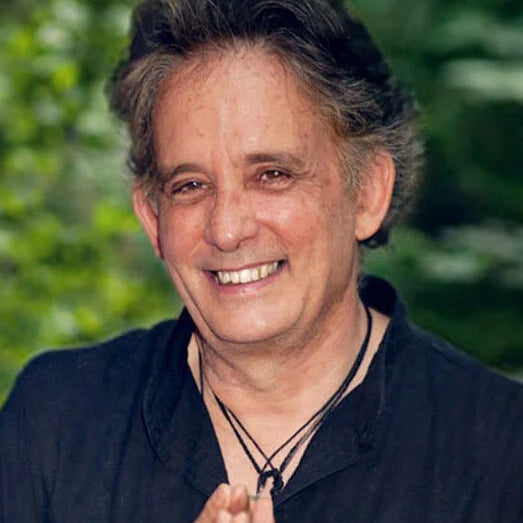 Andrew Harvey, TEPP participant, with gray hair and a black shirt against a blurred green background