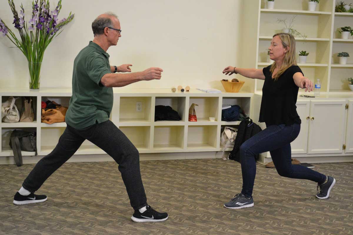 Philip and workshop participant doing a lunge